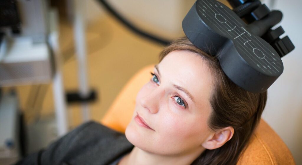 Woman receiving TMS as part of MeRT treatment