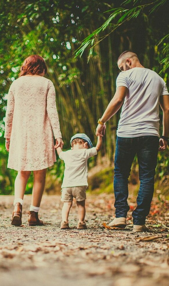 couple walking with child on the autism spectrum