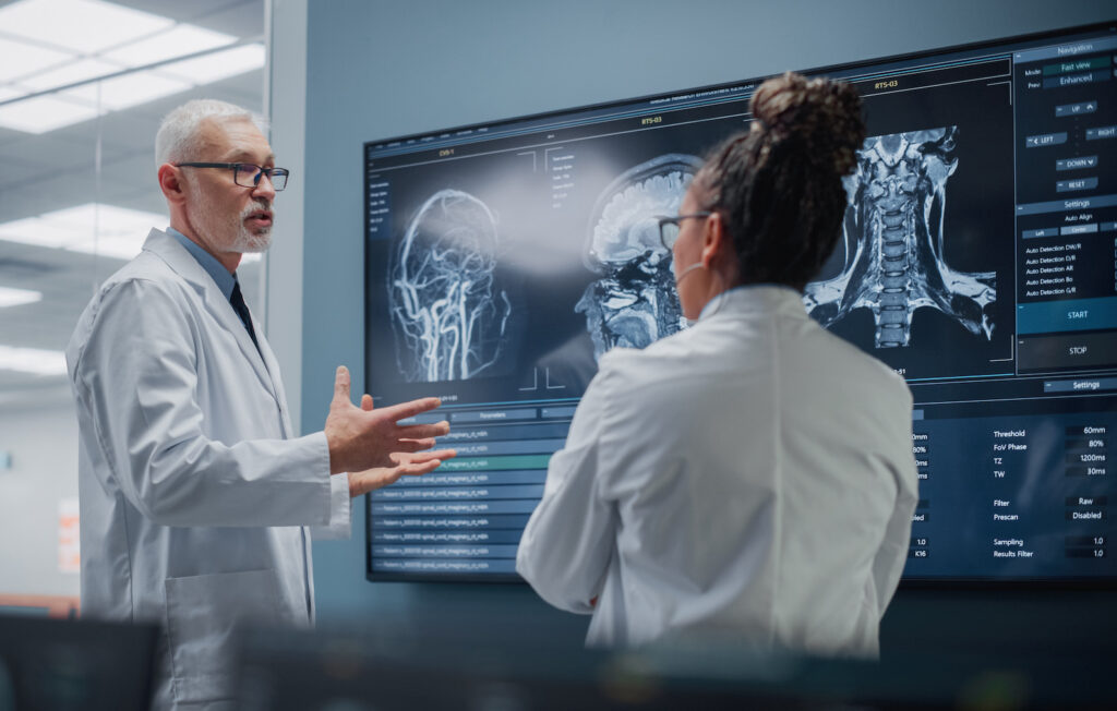 scientist and doctor discussing brain scan and MeRT