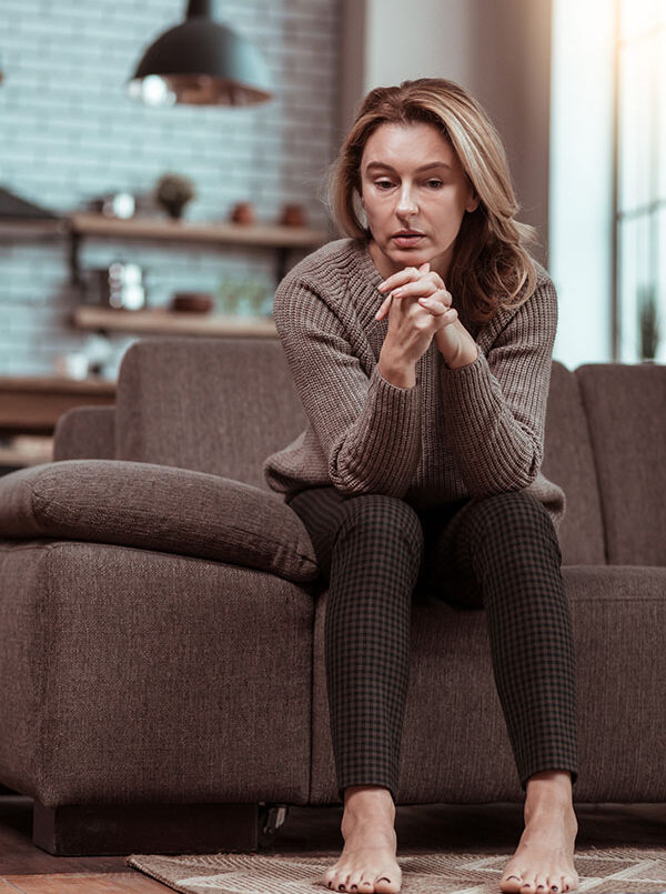 Woman with anxiety sitting on a couch