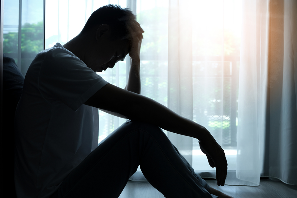 man with treatment-resistant depression sitting in the dark