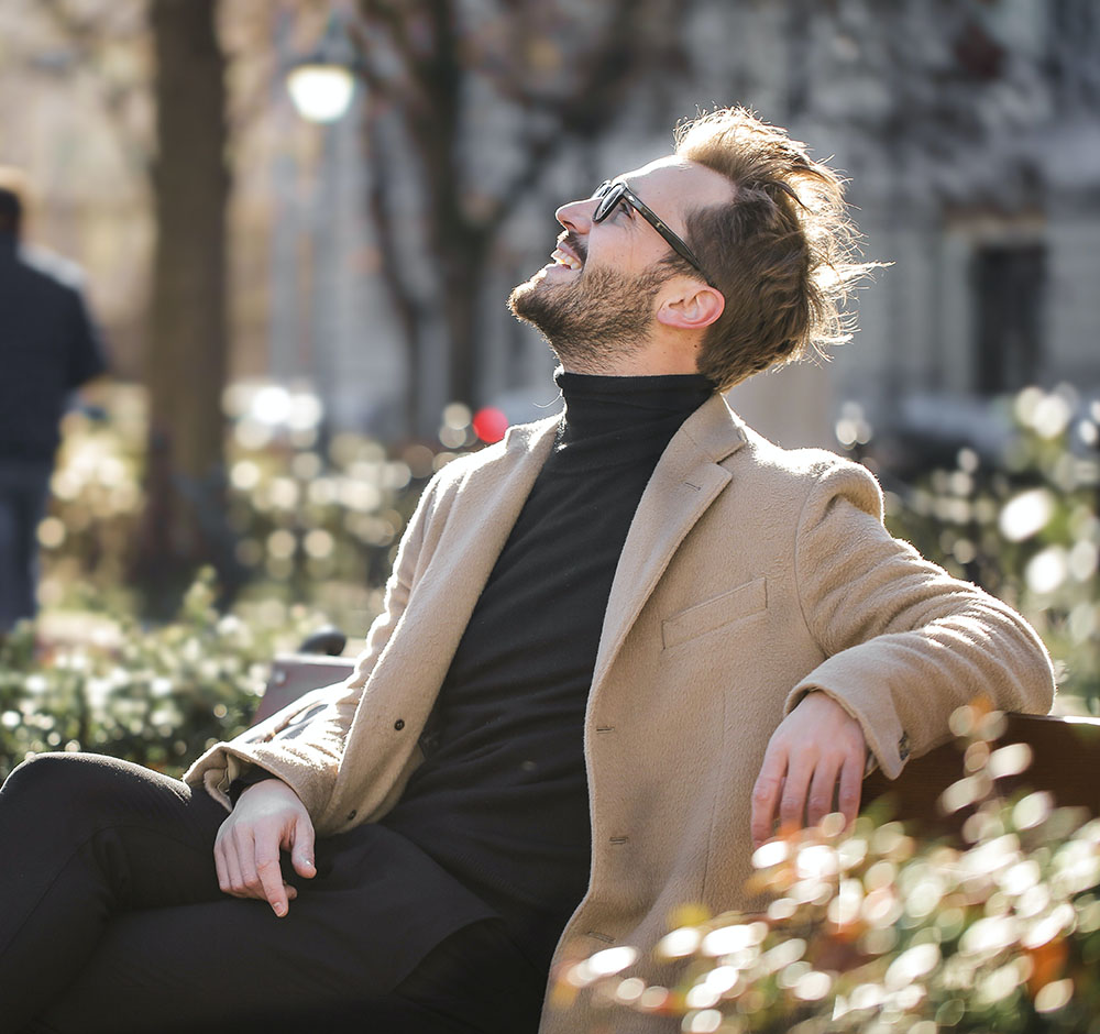 Happy man after MeRT treatment, sitting in a park