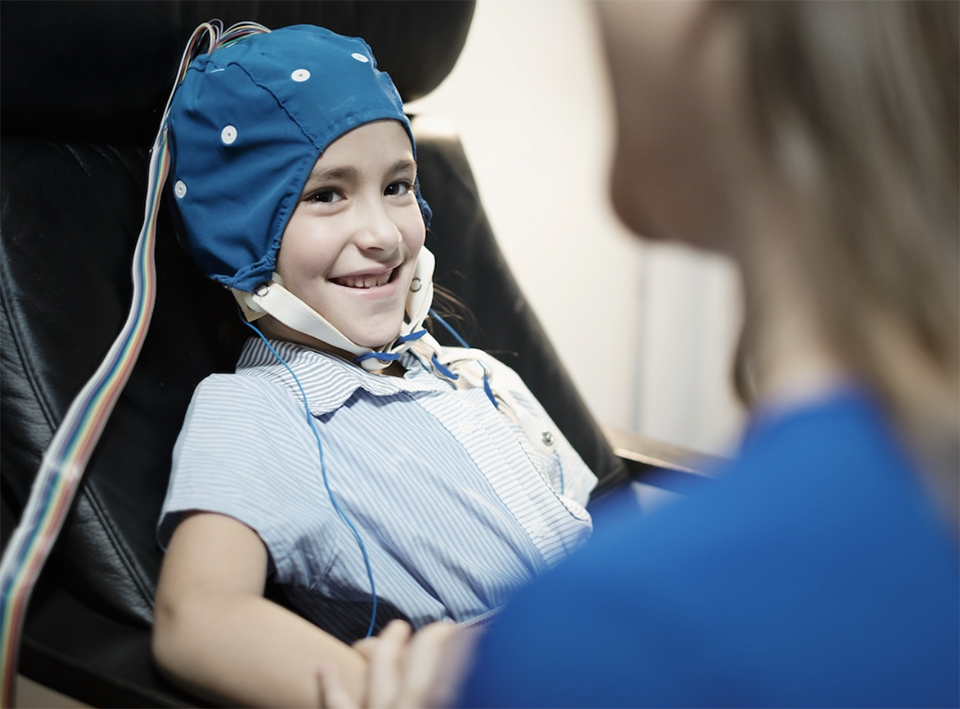 Girl with autism getting an EEG scan