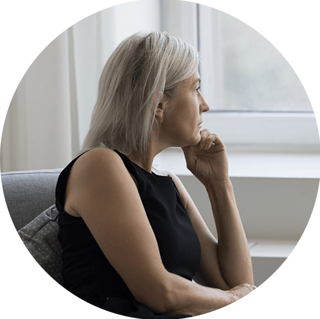 woman with depression looking out the window